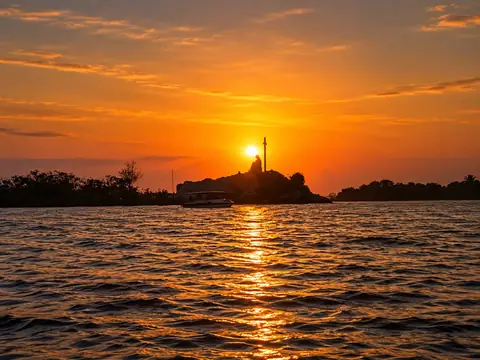 Sunset over the Poovar estuary with a boat – Poovar Boating